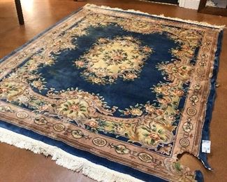 Lower Level:  A blue/multi-color carved  Chinese rug is sold "as is."  It measures 7'  10"  x  10'  3."