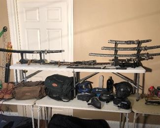 Lower Level:  Canvas bags; boots; paint ball equipment and Samurai and Katana swords are shown.  Some of the swords are individually priced, however, the three on a stand at the right are priced as a SET.