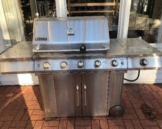Back Yard-Patio:  A stainless steel JENN-AIR grill measures 72" wide x 25" deep.  The grill cover has a thermostat; and the lower doors hide a propane tank.  The side wheels make it easy to move in to your vehicle upon purchase.