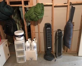 Lower Level-Tool Room: Several useful items include: two sleeping bags; one backpack;  a JANSPORT tent and stakes;  two LASKO tower fans; four unopened CLEAN & SIMPLE super cleaner concentrated solutions in one gallon bottles; a three-drawer organizer;  and BEHR ceiling paint.