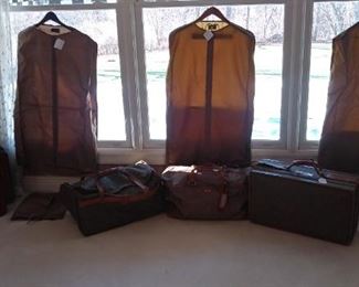 Master Bedroom-Upstairs:  Various pieces of HARTMANN tweed and herringbone luggage as well as leather attache cases are displayed with nylon Hartmann garment covers.