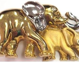 18k two tone double elephant brooch with diamond eyes.