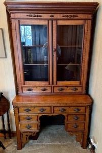 Wow! Beautiful! This antique Victorian writing secretary desk  measures 21x40x74 inches and is crafted from curly maple and the accent/trim pieces are likely walnut. Features two glass doors on the top with a fold out writing desk and ample drawers for storage. 
