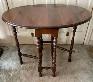 Vintage Gate Leg Table. This lovely gate leg table measures 40x30x31 inches when it is extended and when it is closed it measures 31x12x30 inches. Likely crafted in walnut and in overall good condition with a beautiful finish with some light wear  consistent with age and use which is pictured. 