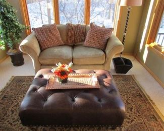 Let's sit and enjoy the sun. OK, maybe it's just me.Sofa is 69" long 40" deep. Leather ottoman is 43" wide by 31"deep and 18 high