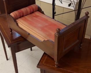 Victorian doll bed (sitting on top of two tables)