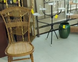 Wicker side chair, golden shelf unit, iron plant holder, queen size metal headboard, American art pottery floor vase/umbrella stand,