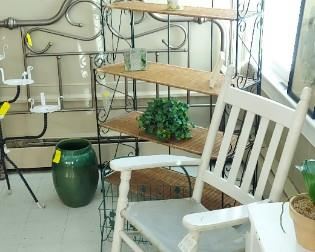 Foldable 5 shelf baker's rack, antique white porch rocker,  table with magazine racks painted white. small round, white metal table