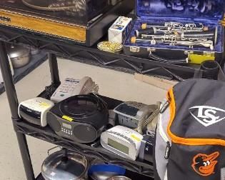 Bundy clarinet in case, turn table, alarm clock/radios, etc.