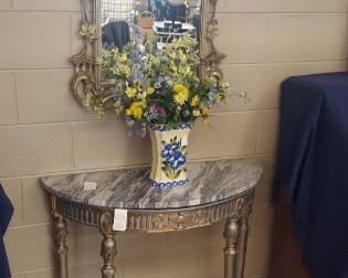 Marble top demi-lune table, beautifully ornate wall mirror.