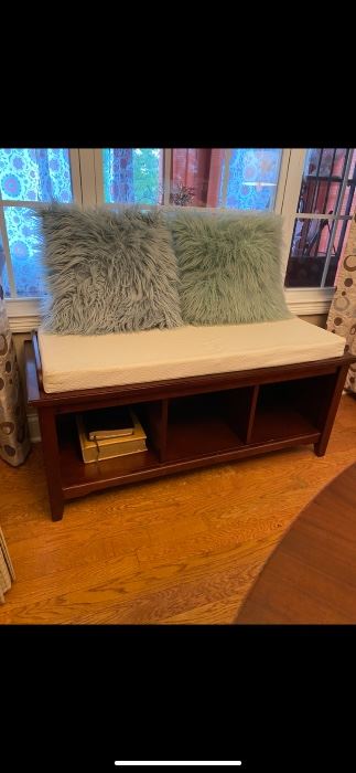Bench with 3 cubbie holes.  Comes with cushion.   Very solid piece of furniture!
