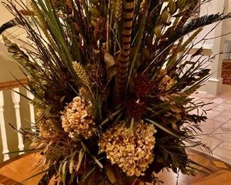 Gorgeous designer floral arrangement with feather accents