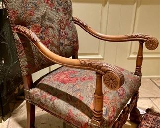 Antique Louis XV style upholstered chair, with ornate carved design and nailhead accents
