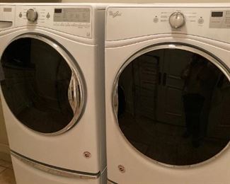 PAIR OF WHIRLPOOL FRONT LOAD WASHER AND DRYER ON STANDS WITH PULLOUT DRAWERS