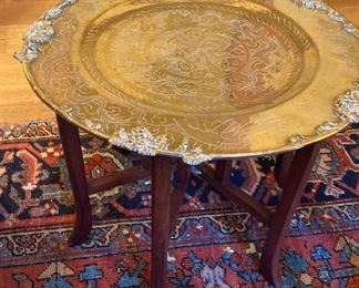 ANTIQUE BRASS PLATE TOP TABLE WITH ORIENTAL DESIGN ON SABER STYLE LEG BASE