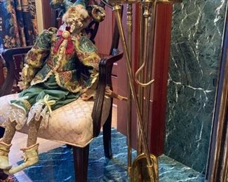 ANTIQUE JESTER PUPPET ON STRINGS SITTING ON PETITE ANTIQUE CHIPPENDALE CHAIR, ALSO SHOWN ARE SET OF ANTIQUE BRASS FIREPLACE TOOLS ON STAND