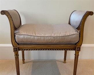FRENCH ANTIQUE BENCH WITH FLAIRED SCROLLED ARMS, FLUTED LEGS AND UPHOLSTERED SILK CUSHION