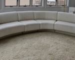 Curved Contemporary Sofa. Super cool and unique sofa! Unfortunately there are several stains that can be seen in the photos and unknown if removable with cleaning. Measures 171” wide from arm to arm, 16” high to the seat and 29” high to the sofa back. 