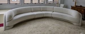Curved Contemporary Sofa. Super cool and unique sofa! Unfortunately there are several stains that can be seen in the photos and unknown if removable with cleaning. Measures 171” wide from arm to arm, 16” high to the seat and 29” high to the sofa back. 