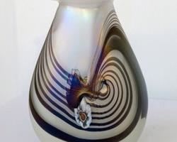 Iridescent Swirled Art Glass Vase. Signed HAT. Measures 7.25” high and 5.5” wide at the base.