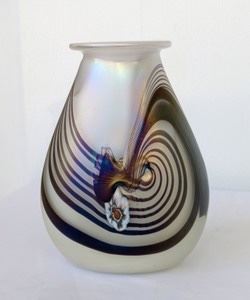 Iridescent Swirled Art Glass Vase. Signed HAT. Measures 7.25” high and 5.5” wide at the base.