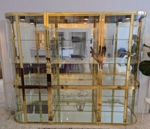 Set of Three Exquisite Brass Curved Contemporary Glass Display Cabinet. A beautiful cabinet! Kind of a show stopper piece!  There is some light wear on the brass finish, but in overall great condition. Total measurement of  84” wide 15” deep and 77” high