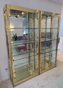 Two Large Brass Glass Display Cabinets. These stunning pieces of furniture can showcase your treasures! Do you have an amazing collection you want to display? These cabinets are for you! One of the doors does not stay shut, but likely needs a new magnet or easy repair.

Each Measures 34” wide 13” deep and 78” high.