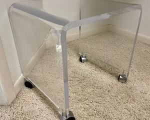 This lucite stool on casters measures 17x17x15 inches. Overall in good condition with light wear. 