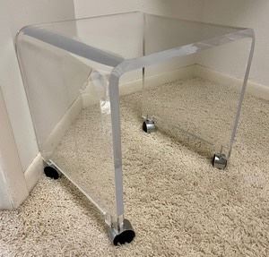 This lucite stool on casters measures 17x17x15 inches. Overall in good condition with light wear. 