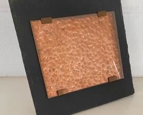 This copper and slate picture frame measures 12x12 inches.