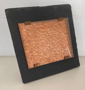 This copper and slate picture frame measures 12x12 inches.