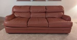 Classic Leather Sofa. This item matches the previous lot.  There are few imperfections on the lower front that can be seen in the photos. The sofa is in otherwise excellent condition. Measures 84” wide from arm to arm, 28” deep, 17” high to the seat and 30” high to the sofa back. 