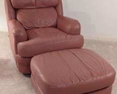 Classic Leather Armchair and Ottoman.  There are a few small marks, but both pieces are in otherwise excellent condition. The chair measures 32” wide from arm to arm, 28” deep, 17” high to the seat and 32” high to the chair back.