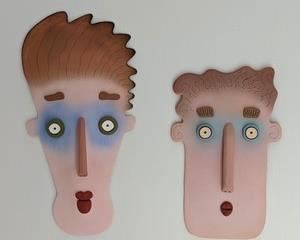 Pair of Unique Artist Designed Contemporary Face Sculptures. Fun wall hangings are signed by the artist, but difficult to read the signature. The largest measures 12” x 23”.