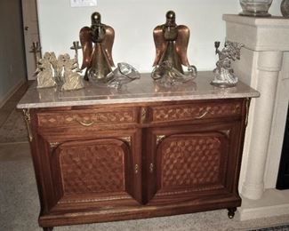 Pair of tall brass and copper angels. Pair of large glass cornucopias.  Nice marble topped cabinet with brass trim at corners and pulls.