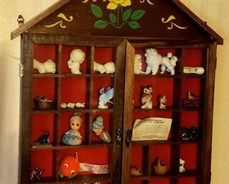 Wall frame containing miniatures has glass doors