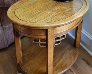 oval wooden Asian motif  table with lower shelf 