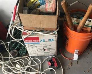Bucket of painter’s sanding supplies. New mini Shop-Vac and more extension cords than anyone has a right to own.