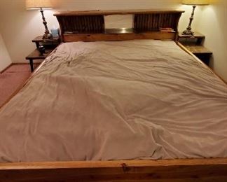 Very old waterbed, platform bed side tables and lamps