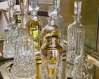 Baccarat, Orrefors, and Wedgewood decanters along with other barware