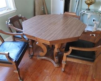 game  table  and  four  chairs-  it  has  one  leaf
