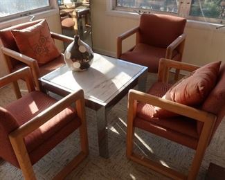   The  table  is  26   x  26    and  there are   4    rust  colored  chairs.  The top  appears  to  be   marble   and  has chrome  color  trim  and  legs.