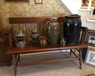 Parsons bench with railroad lanterns and pottery