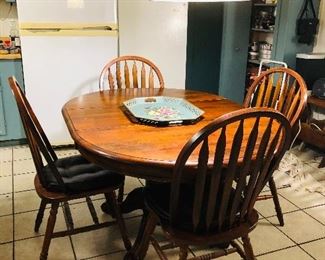 Kitchen table with 4 chairs. Shown with leaf in but can be removed for a smaller table. 