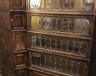 2 parts of the Globe Wernicke stacking oak leaded glass corner bookcase set. There are 10 glass stacks and one central corner unit which you see on the left here, the other five stacks would attach to the other side of that corner unit