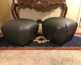 Pair of grey ottomans on casters