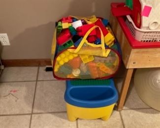 Large bag full of Legos and a Storage Bin