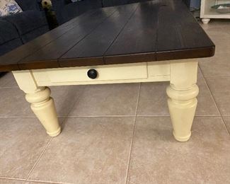 Coffee table with a drawer at each end. 