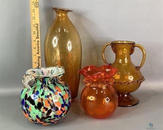 Colorful Vases
One tall amber colored vase with bubble design. No visible cracks or chips One multi-colored doubled handles vase. One handle has broken end. otherwise no other damage seen. One dark orange vase with ruffled edge, appears to be hand blown. No visible cracks or chips. One amber colored double handled vase with swirl pattern. It has chips on the underside of the pedestal and a crack at one of the handles.