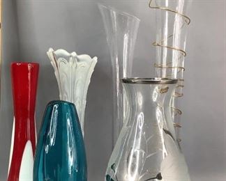 Decorative Vases
One Bohemia crystal vase (as labeled by sticker) with floral design. One blue colored glass bud style vase with teardrop cut out design. One red and white glass bud vase. Two clear glass tall vases, one with gold tone metal wrap. One clear and white glass fluted and ruffle style rim vase. Tallest measures 20"H, shortest measures 9.5"H. No visible cracks or chips.